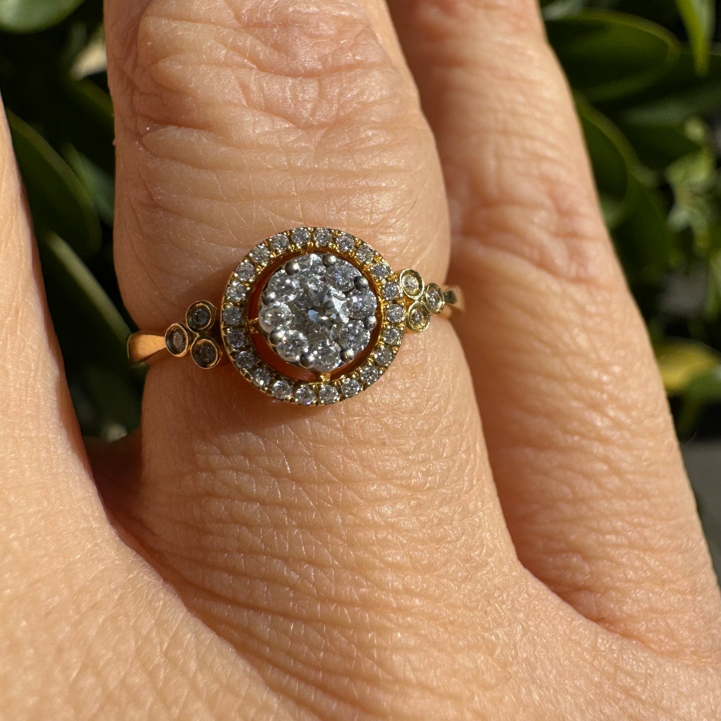 14K gold ring with a round cluster of Diamonds in the center, surrounded by a halo of smaller sparkling Diamonds.