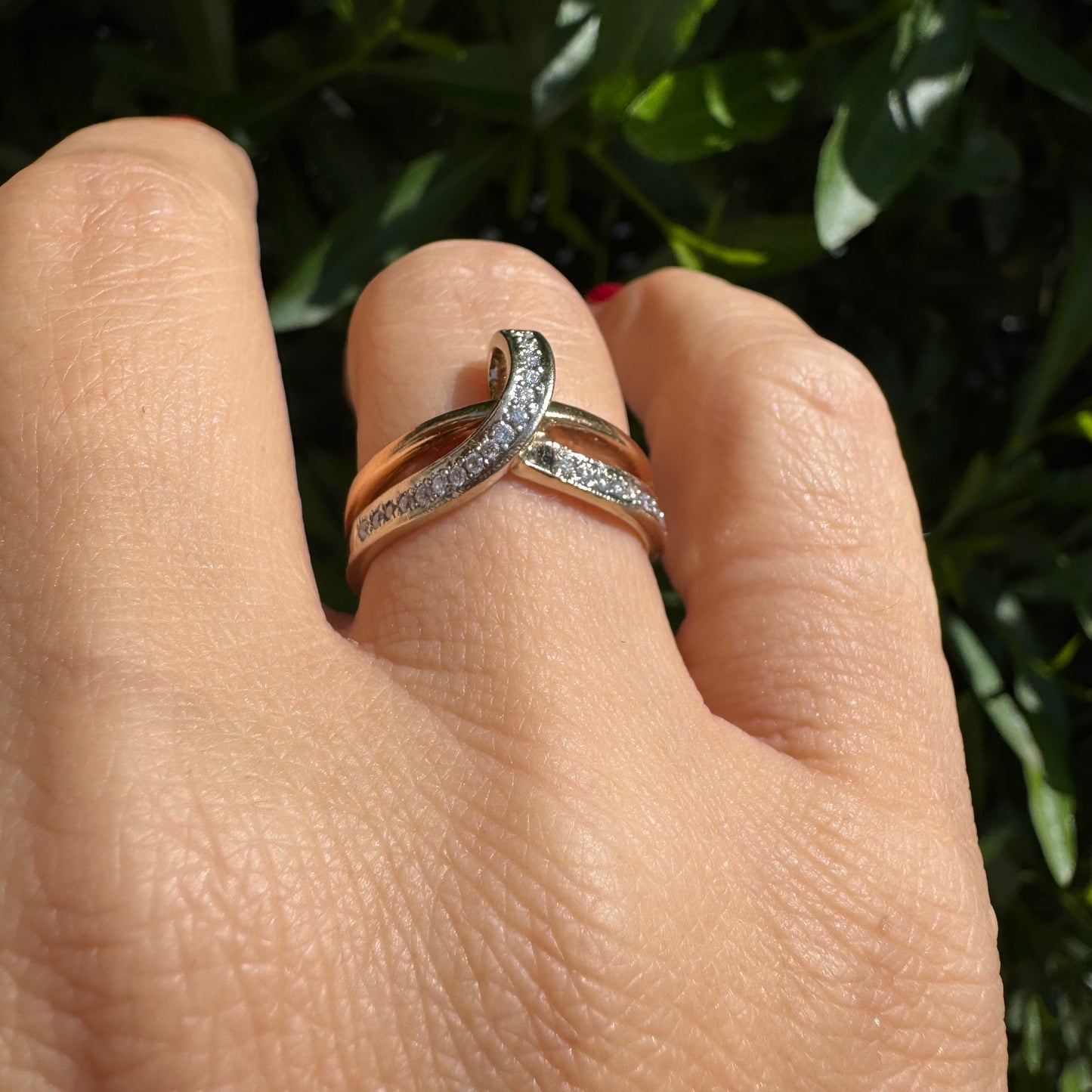 18K two-tone gold (rose & white) crossover ring featuring a row of sparkling Diamonds along each band, creating an elegant and modern design.