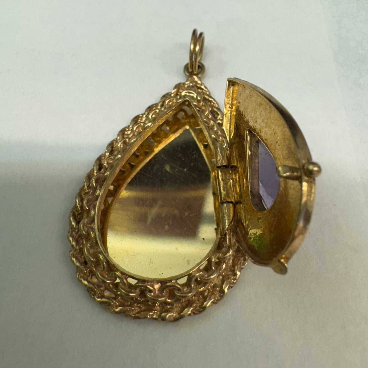 14K gold locket pendant set with an Amethyst gemstone