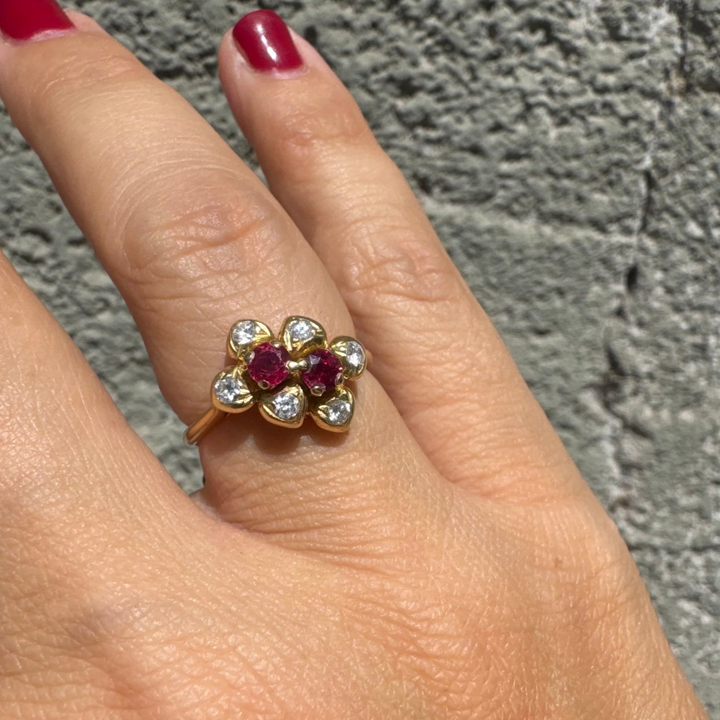 18K gold ring designed like a flower, set with two deep red Rubies and sparkling Diamonds