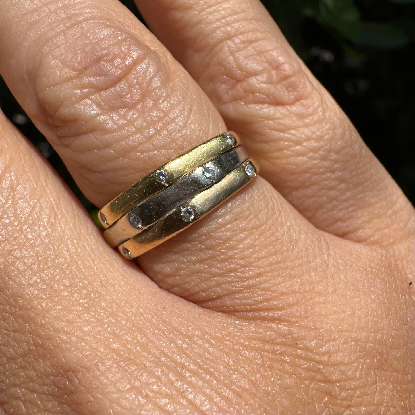 18K gold ring crafted in yellow, white, and rose gold, featuring a triple-band design set with Diamonds