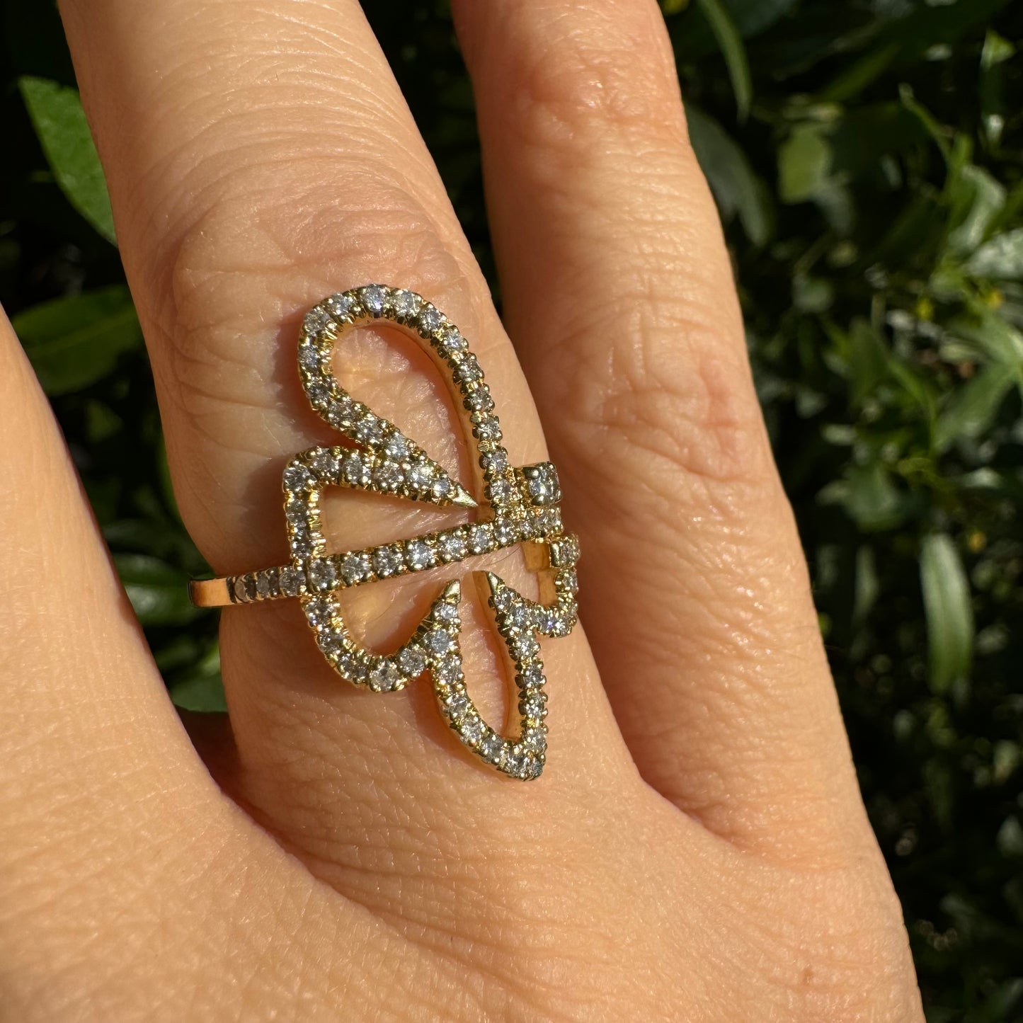14K gold ring in an open butterfly design, outlined with sparkling Diamonds