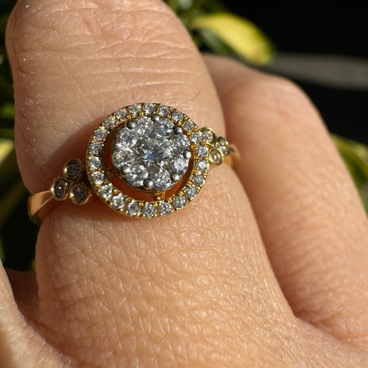 14K gold ring with a round cluster of Diamonds in the center, surrounded by a halo of smaller sparkling Diamonds.