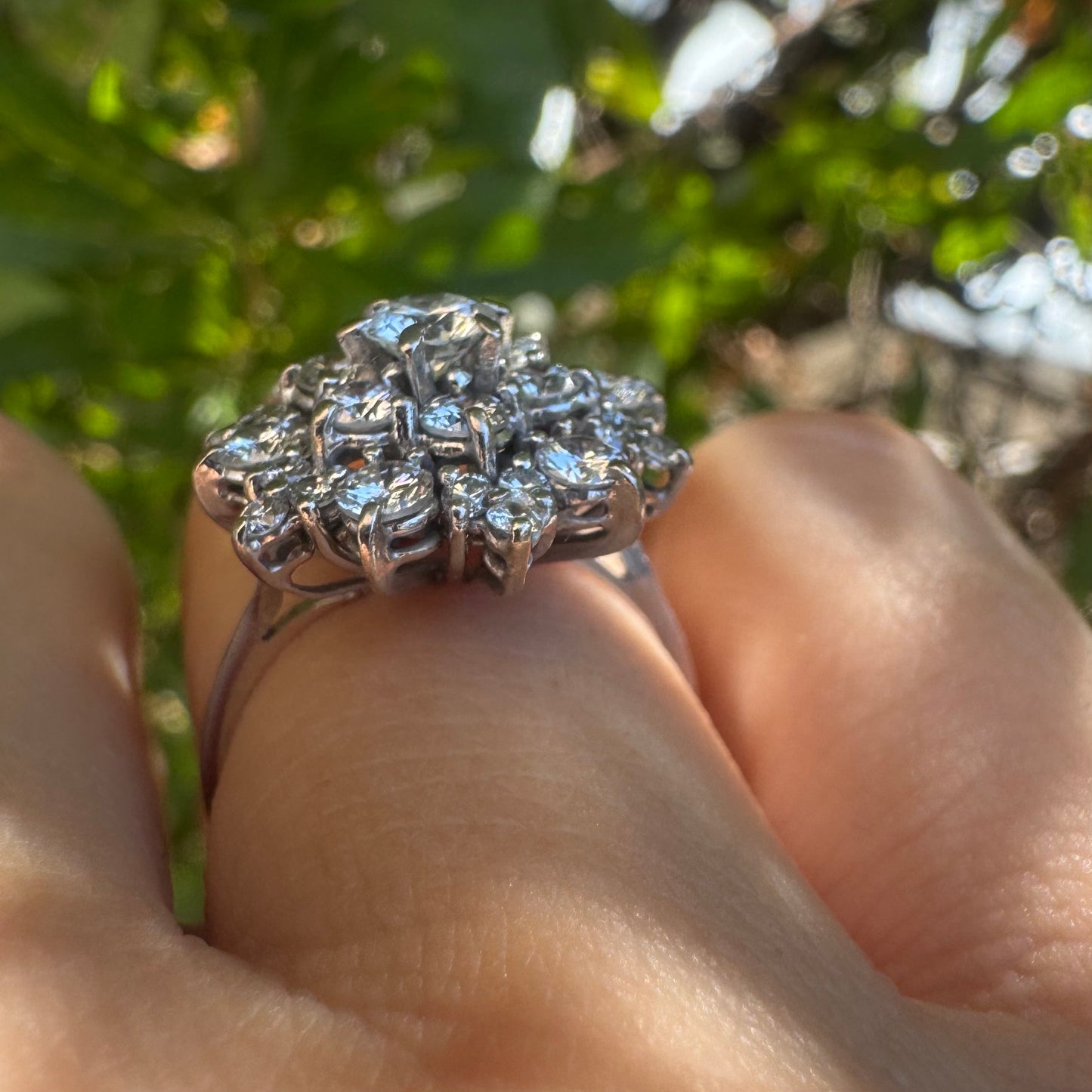 18K gold ring set with sparkling white Diamonds arranged in a floral cluster design