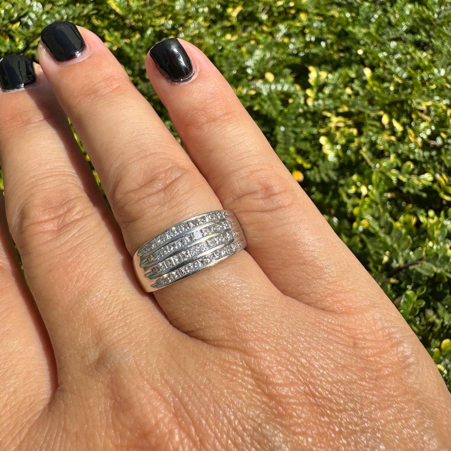 14K gold ring set with four parallel rows of princess-cut Diamonds.