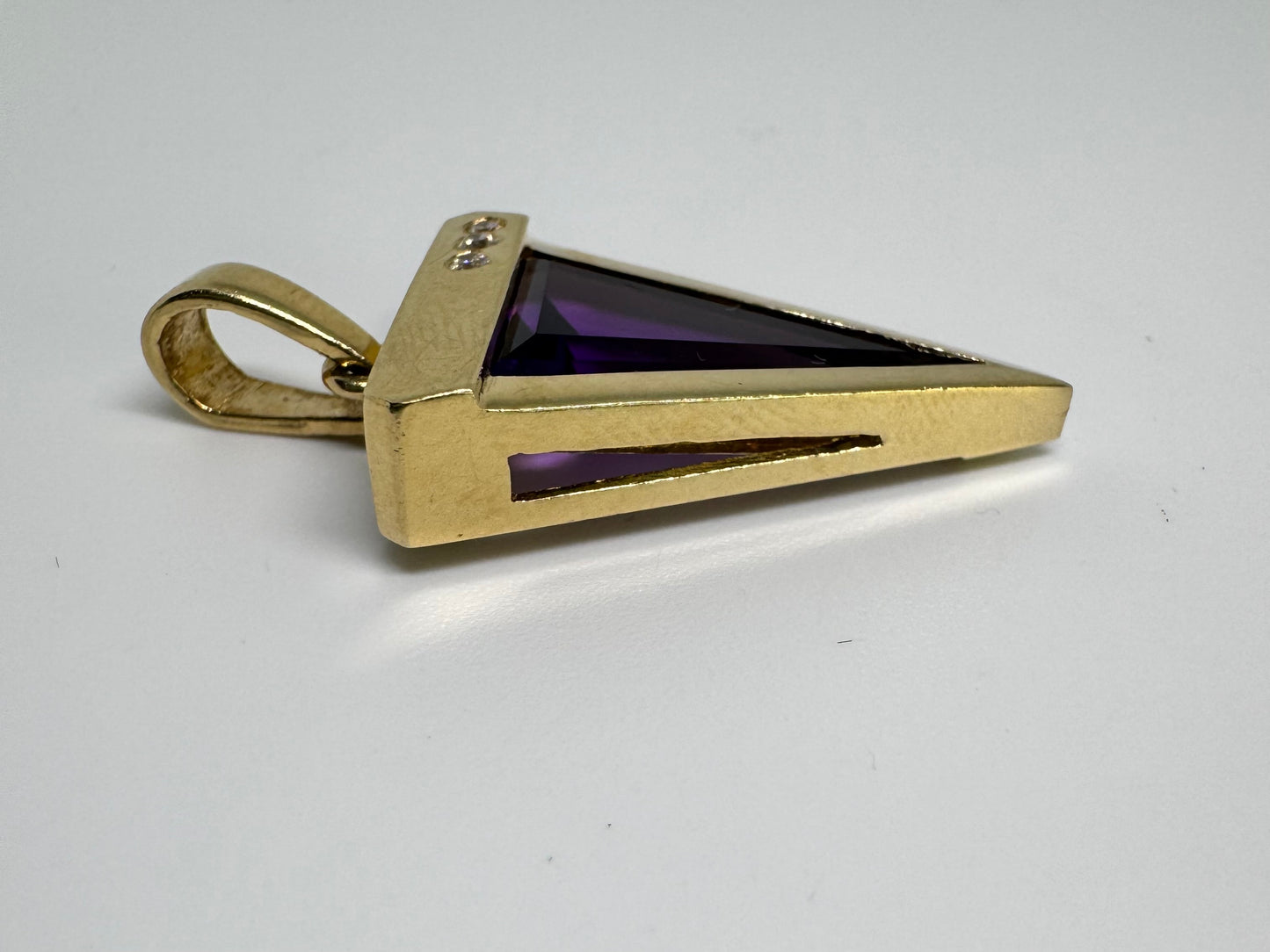 14K yellow gold pendant set with a triangular-cut amethyst and three accent diamonds