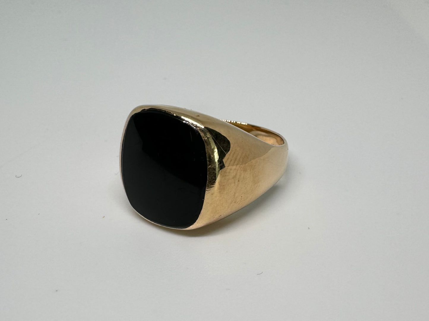 14K bold gold ring set with a smooth, square-shaped black Onyx that creates a sleek and striking look.