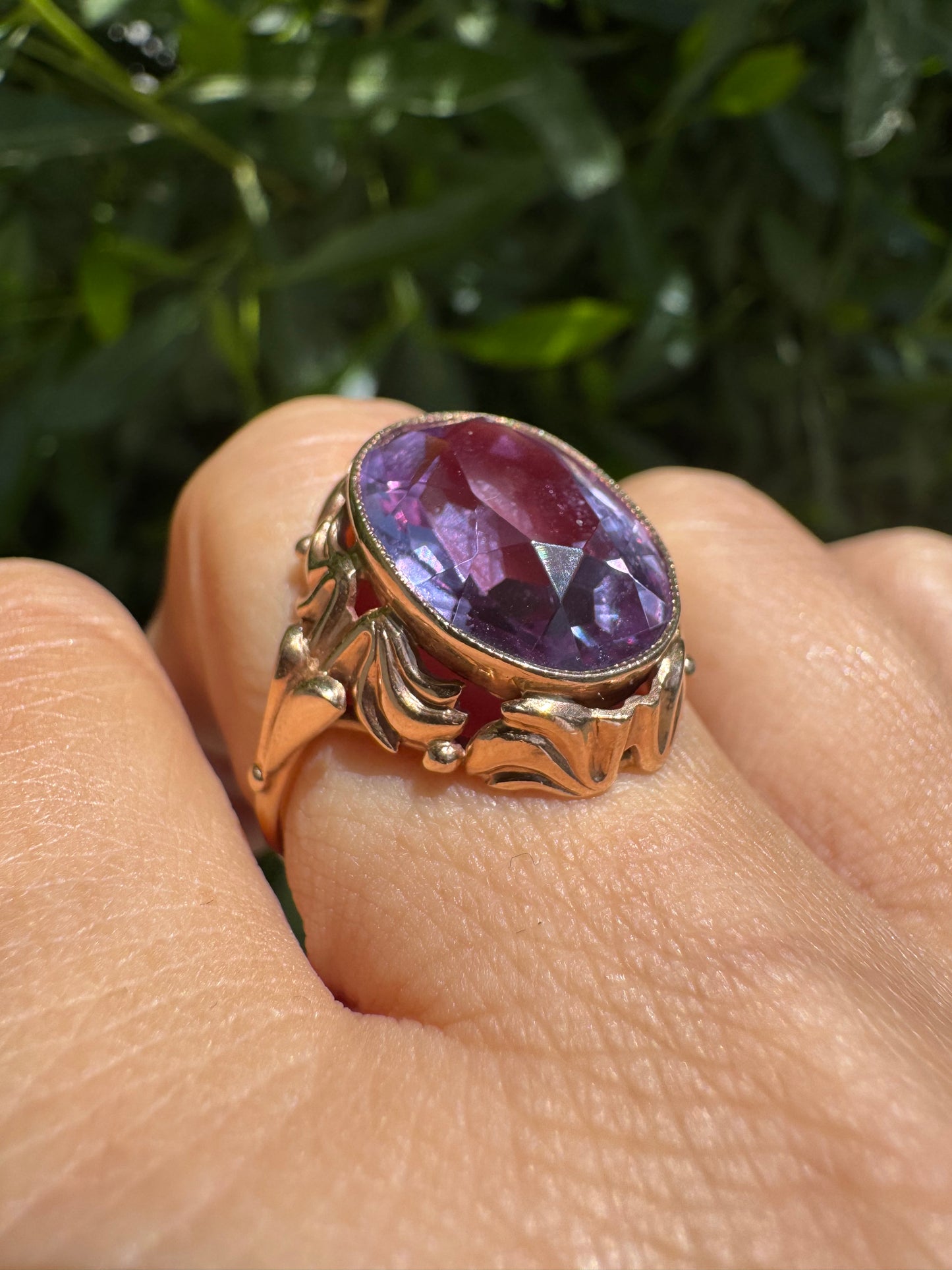 14K gold ring set with a large oval-cut Amethyst in a regal claw setting.