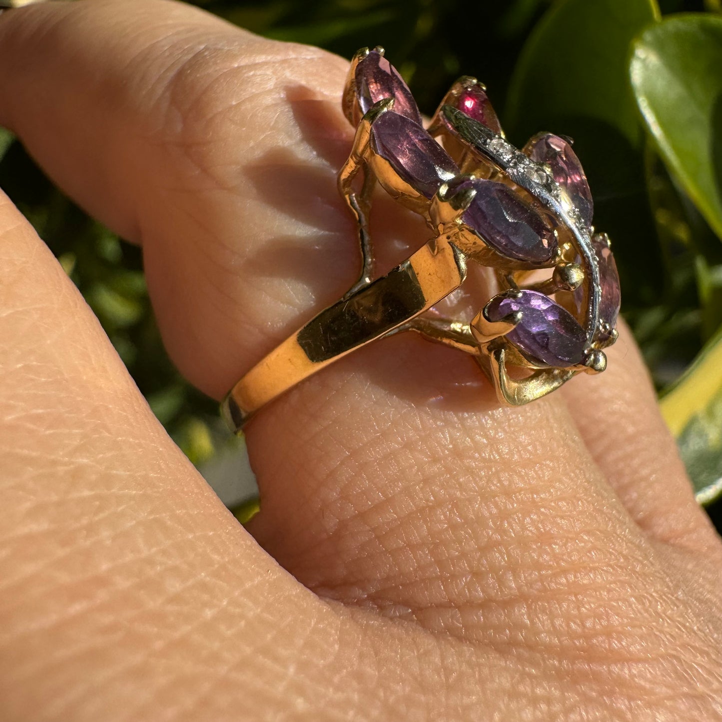 14K gold ring designed in a leaf motif, set with 7 marquise-cut Amethyst and accented by a curved line of sparkling Diamonds