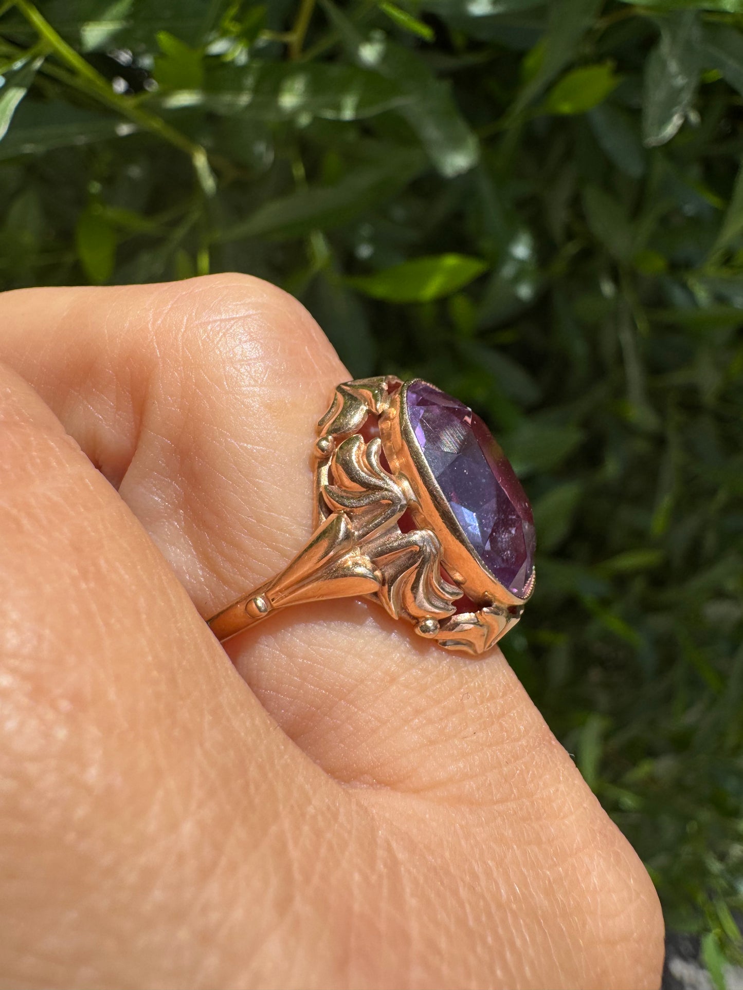 14K gold ring set with a large oval-cut Amethyst in a regal claw setting.