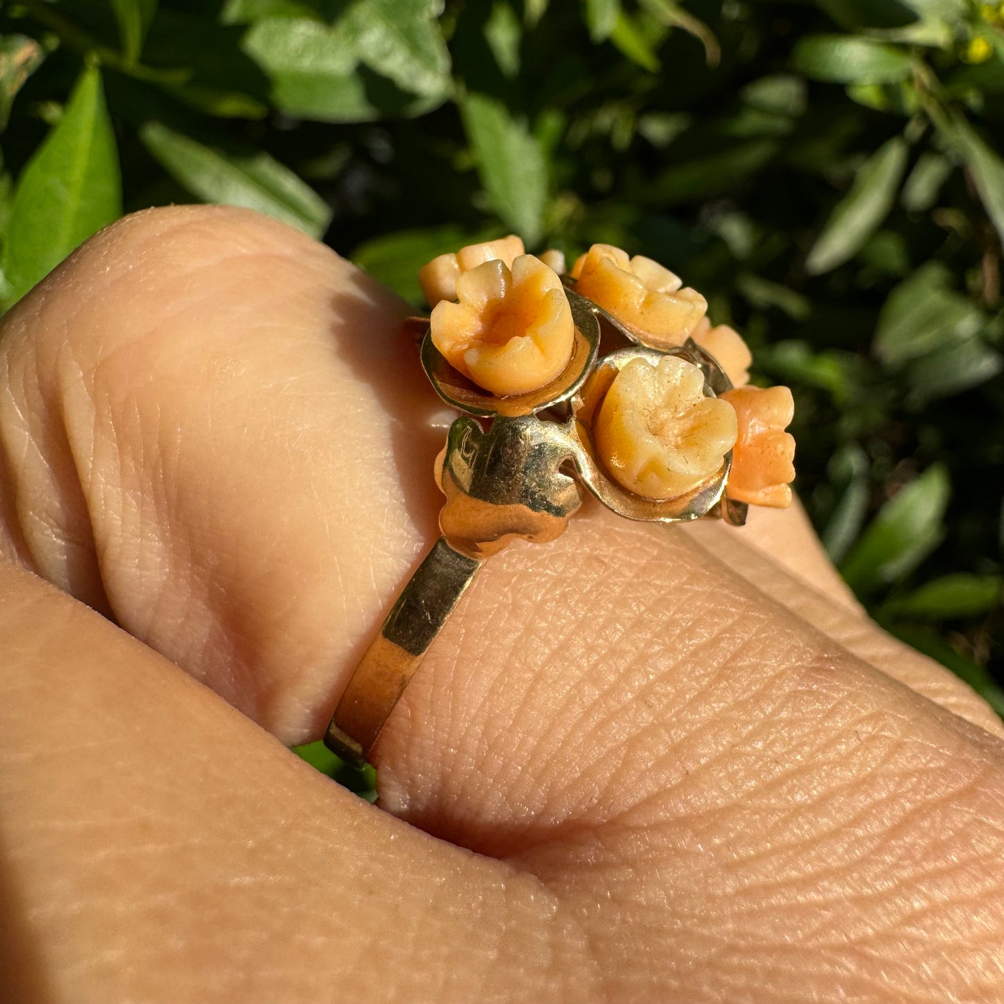 9K gold ring featuring a cluster design with carved Coral flowers in warm orange tones