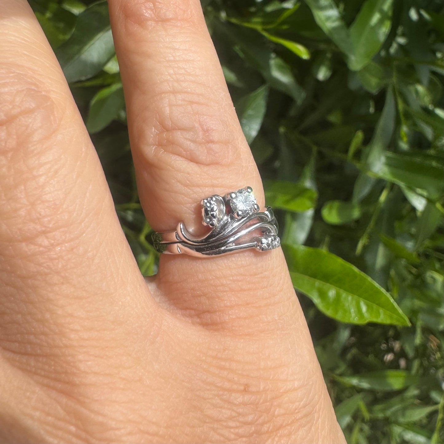 14K gold ring set with round-cut diamonds in a flowing design