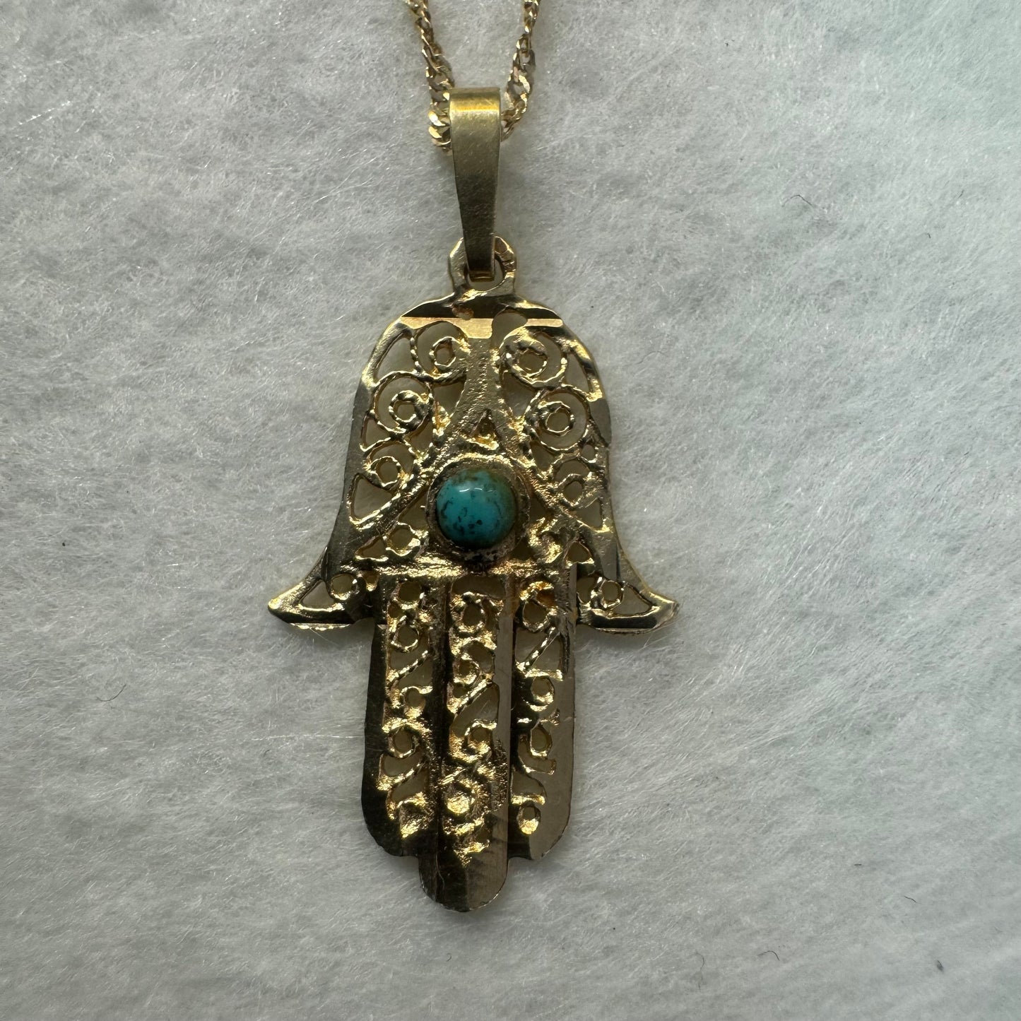 14K gold necklace with “Hamsa” pendant set with a center Turquoise stone