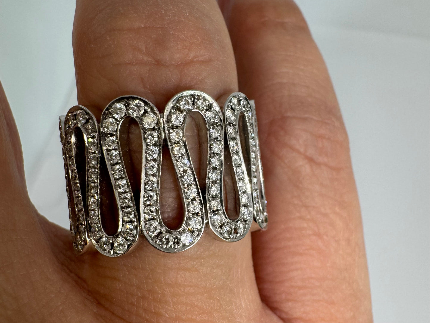 14K gold ring set with shimmering Diamonds in a flowing wave design