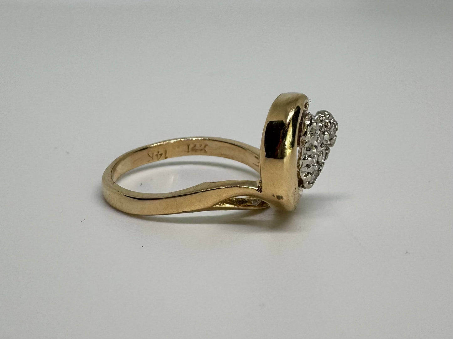 14K gold ring set with sparkling diamonds in a heart-shaped motif