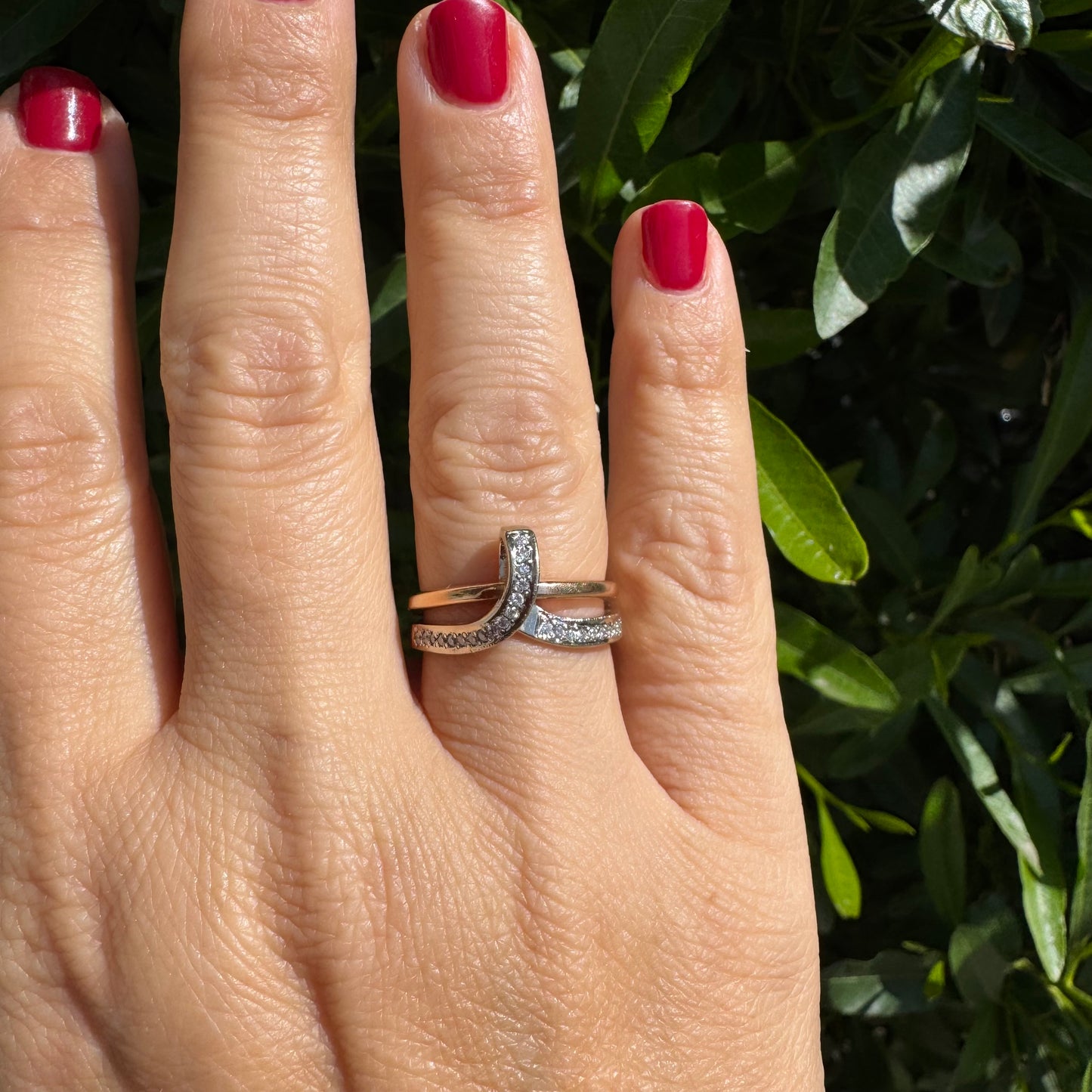 18K two-tone gold (rose & white) crossover ring featuring a row of sparkling Diamonds along each band, creating an elegant and modern design.