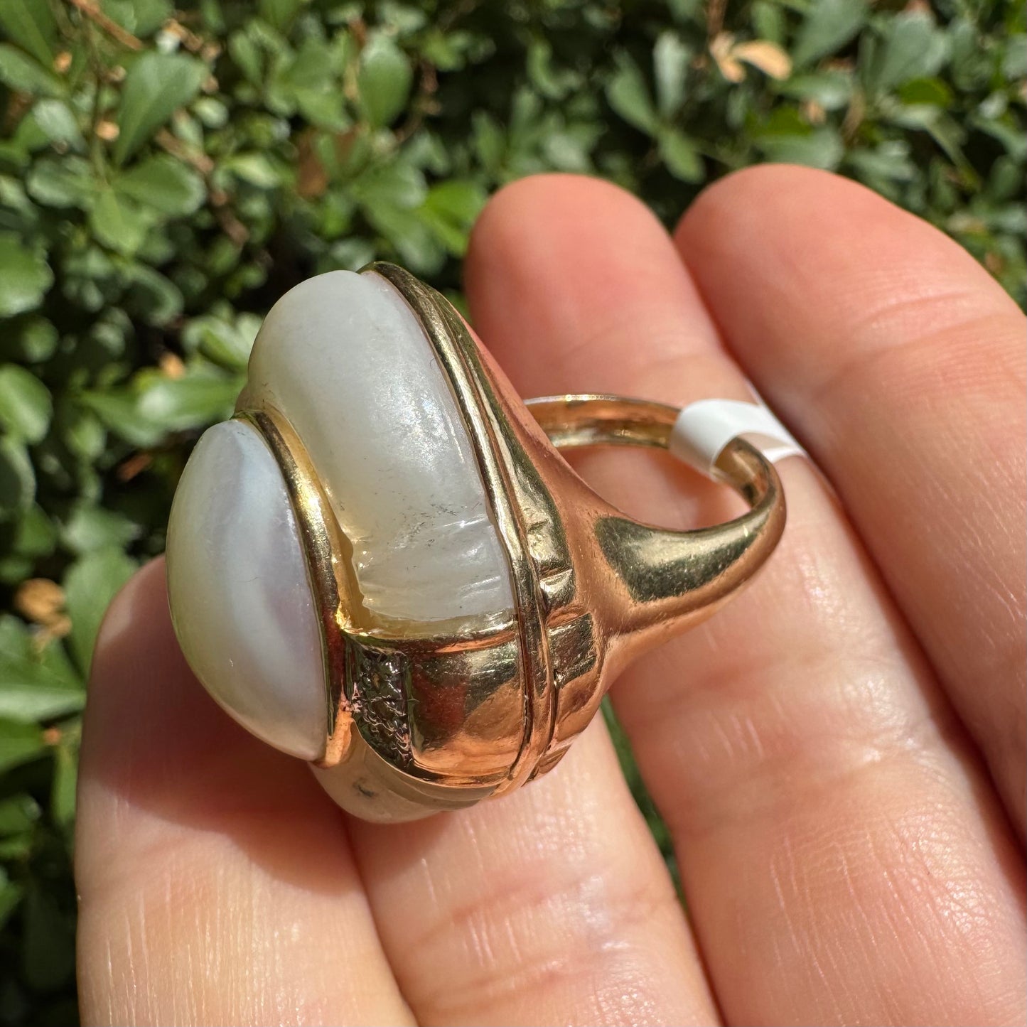 14K gold ring set with a natural mother-of-pearl centerpiece framed by delicate diamond accents