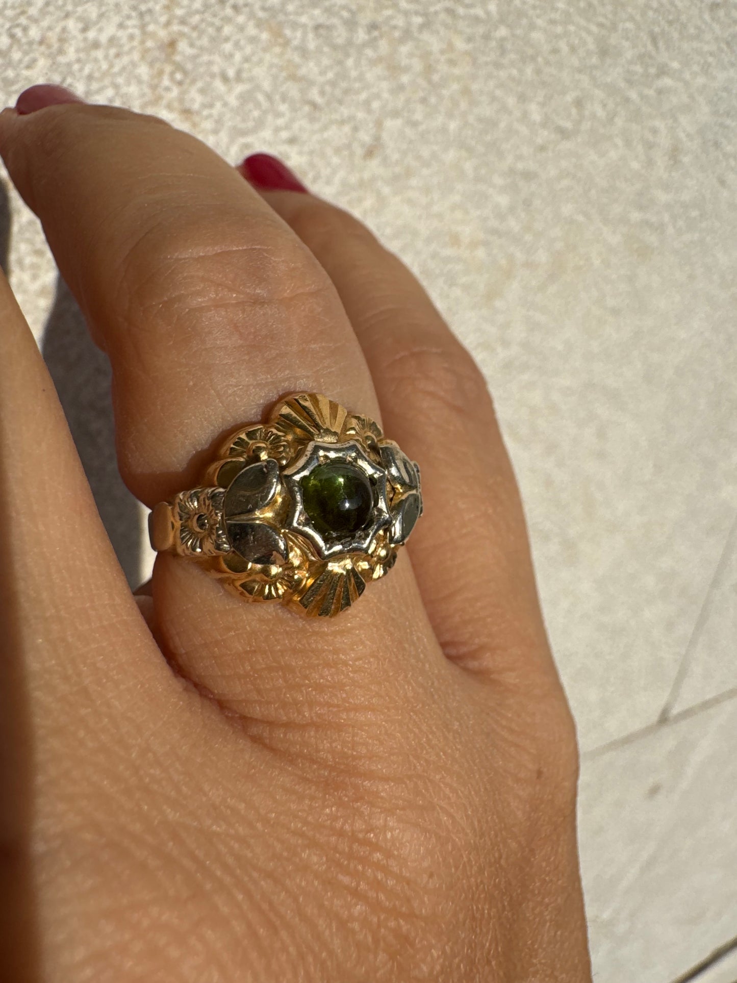 18K two-tone gold ring set with a deep green Tourmaline gemstone.