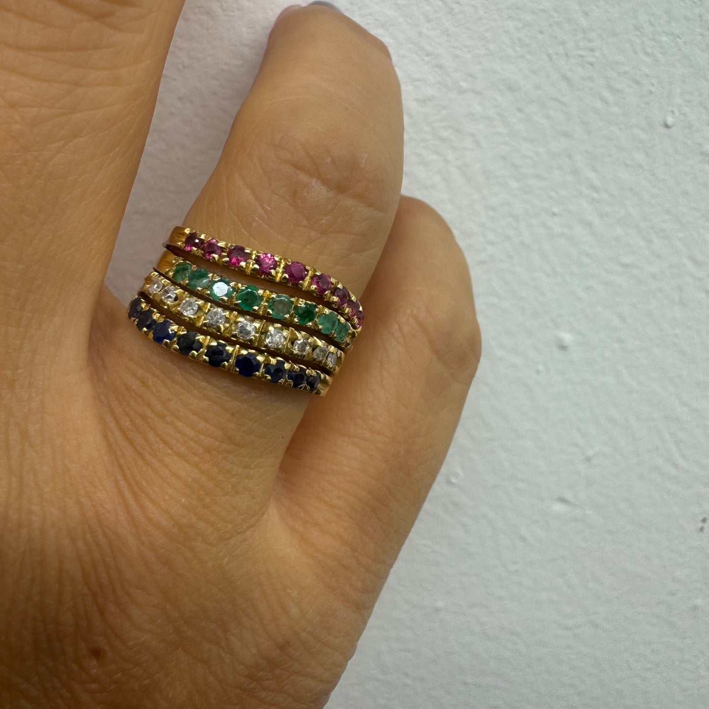 18K yellow gold ring set with vibrant rows of Sapphires, Emeralds, Rubies, and Diamonds