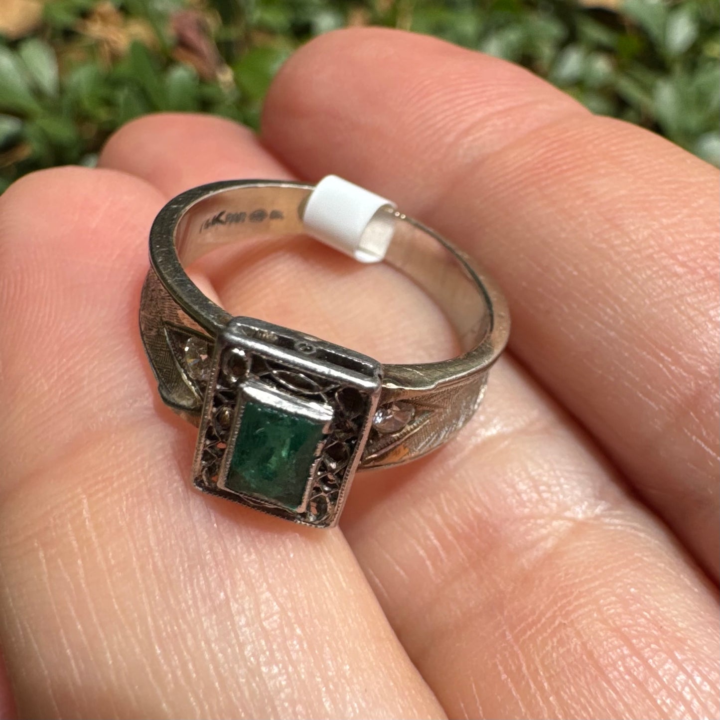 14K gold ring set with a vibrant emerald-cut Emerald at its center, framed by delicate filigree work