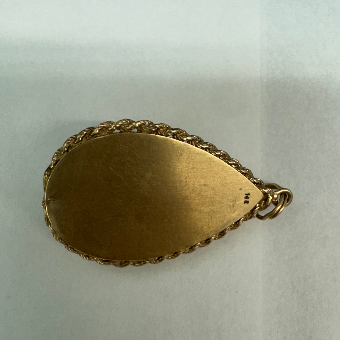 14K gold locket pendant set with an Amethyst gemstone