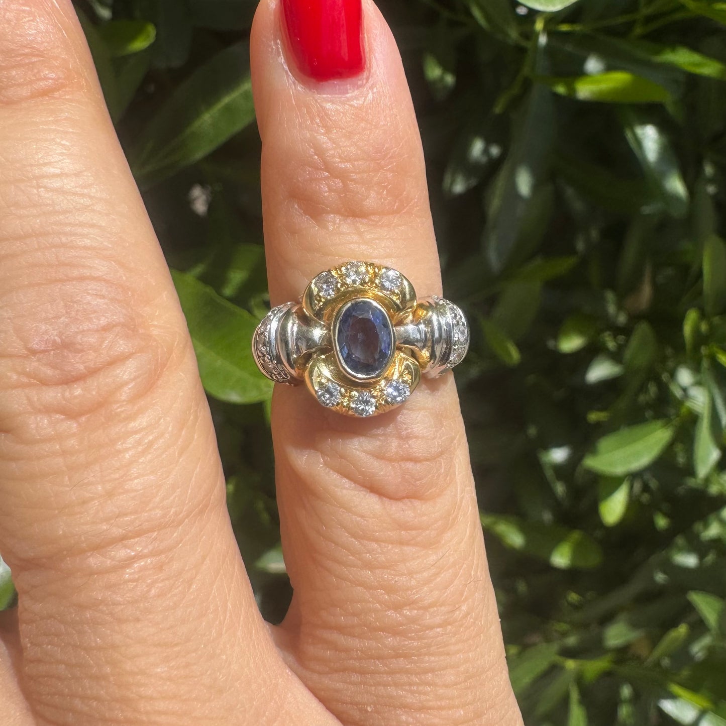 18K two-tone gold ring set with an oval Tanzanite & round brilliant diamonds