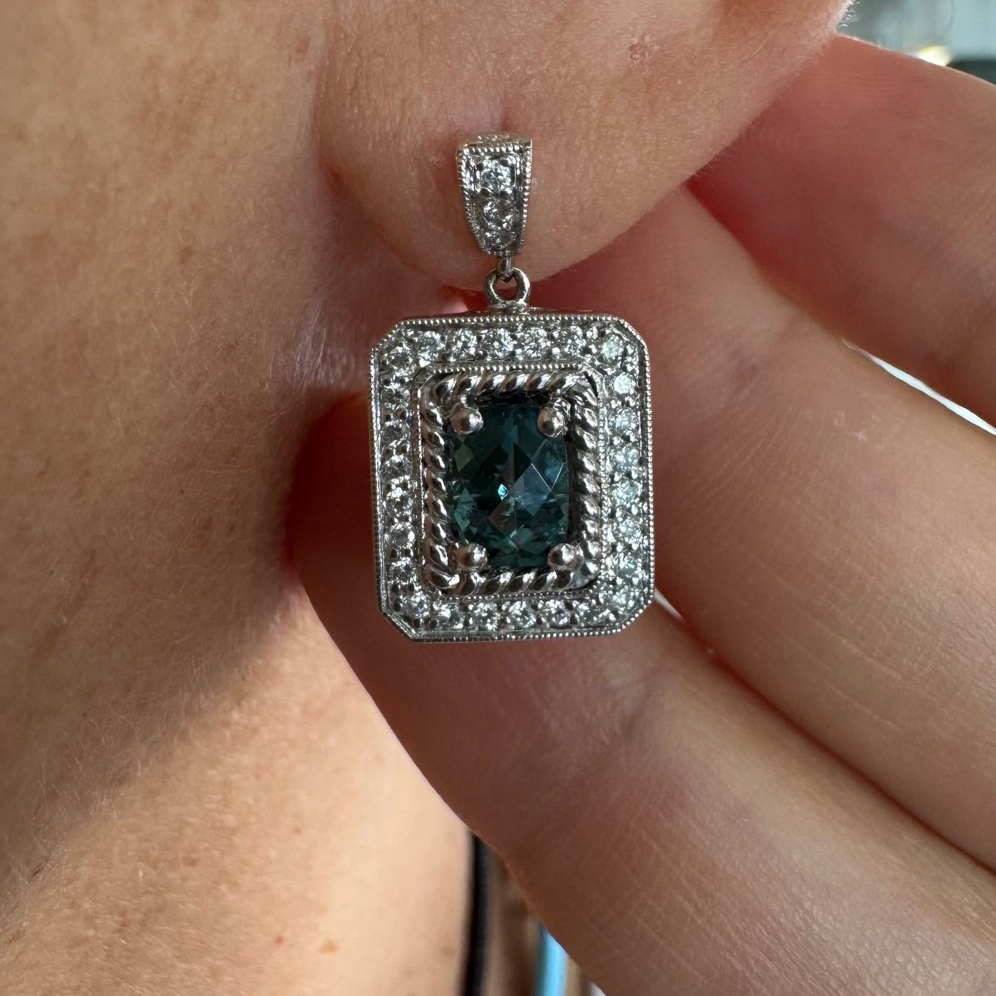 14K gold drop earrings set with emerald-cut Blue Topaz, surrounded by a halo of sparkling Diamonds