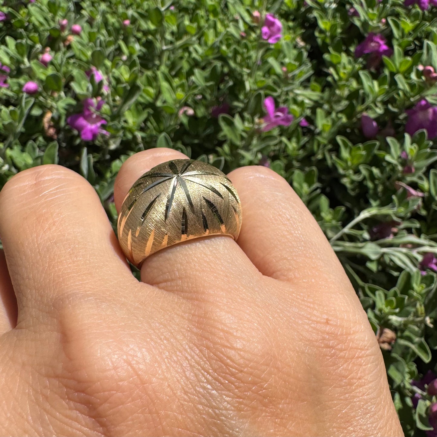 14K gold dome ring crafted in textured gold, featuring intricate engraved starburst detailing