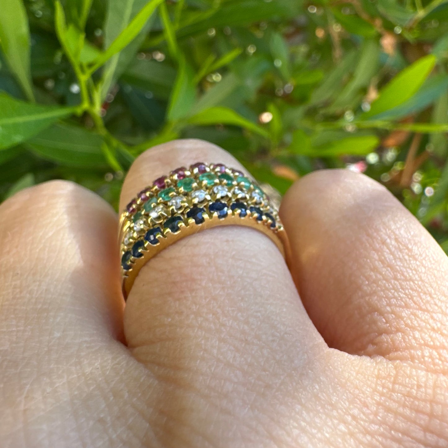 18K yellow gold ring set with vibrant rows of Sapphires, Emeralds, Rubies, and Diamonds