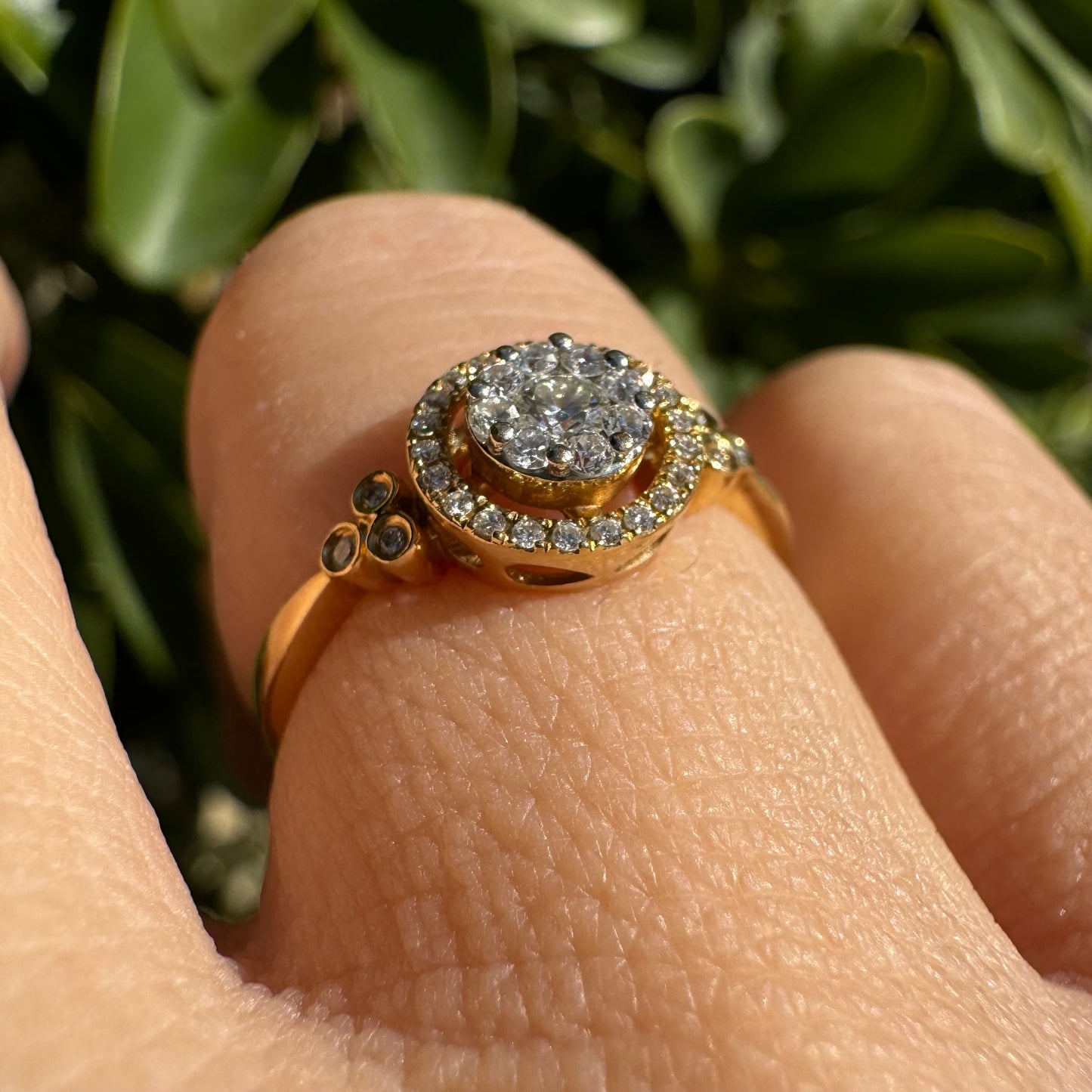 14K gold ring with a round cluster of Diamonds in the center, surrounded by a halo of smaller sparkling Diamonds.
