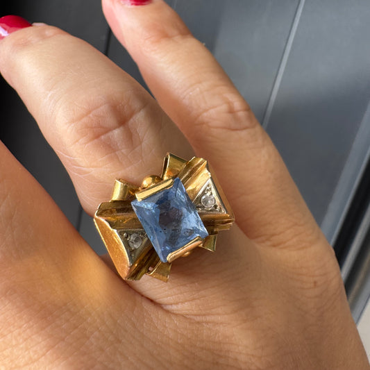 טבעת זהב צהוב 18 קראט בעיצוב פפיון משובצת אבן טופז כחולה בחיתוך מלבני במרכז