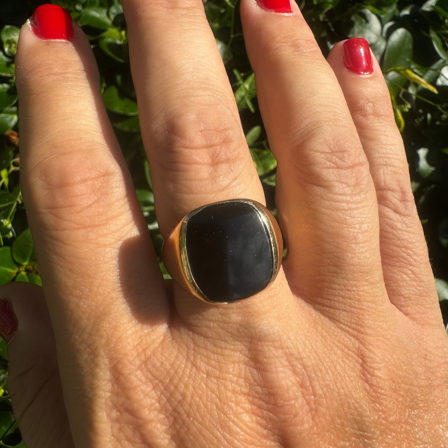 14K bold gold ring set with a smooth, square-shaped black Onyx that creates a sleek and striking look.