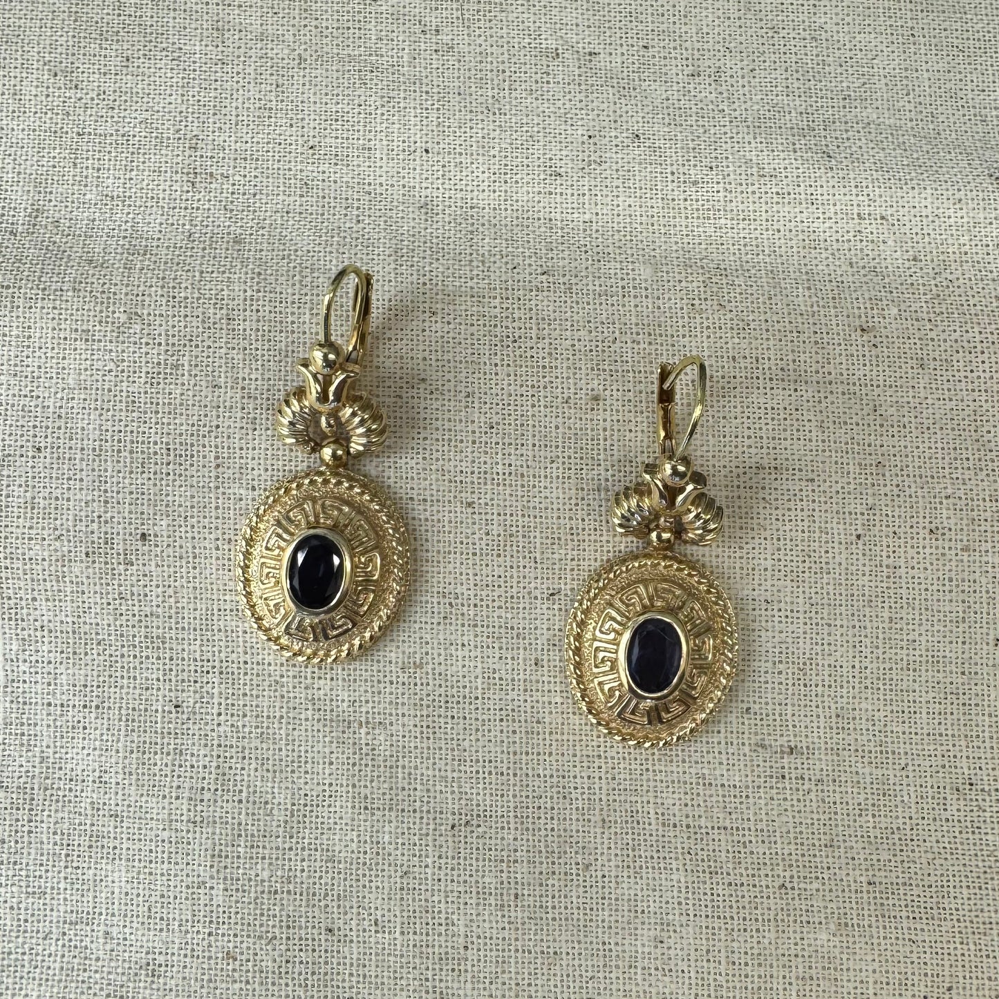 14K gold drop earrings set with Tanzanite in ornate medallion