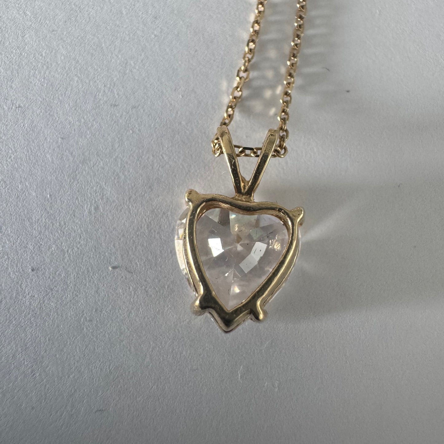 14K gold Heart Pendant set with a brilliant heart-cut clear stone.