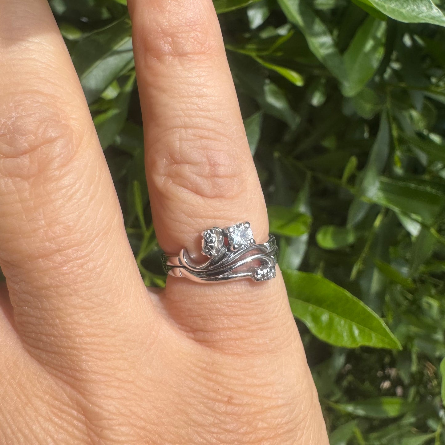 14K gold ring set with round-cut diamonds in a flowing design