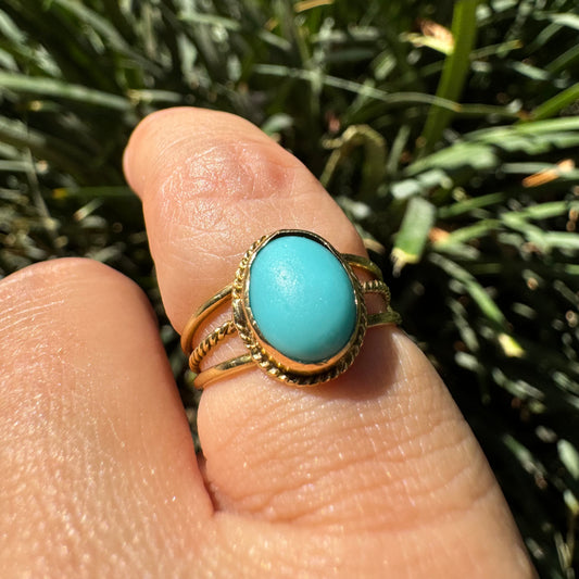 14K gold ring set with an oval Turquoise stone in a delicate rope-style bezel