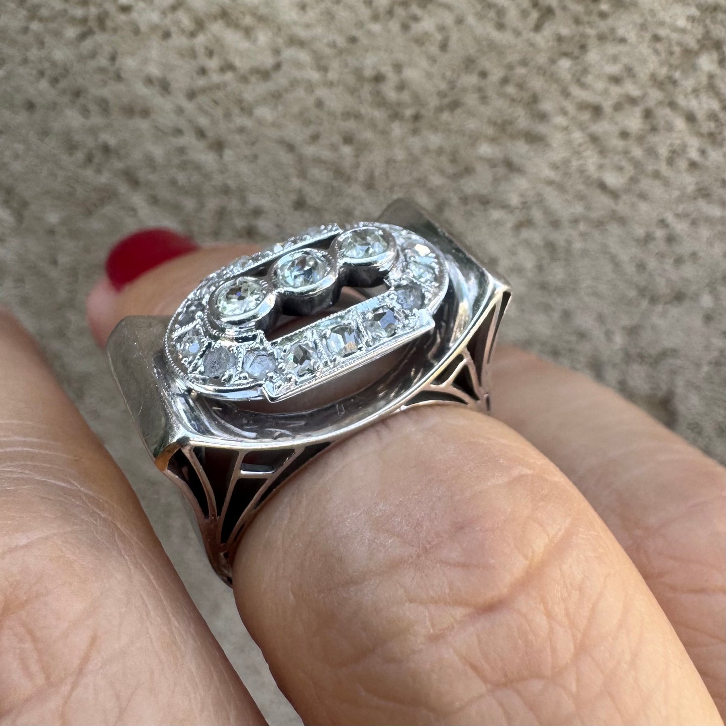 18K gold ring featuring three round 3 Diamonds in the center, framed by a rectangular halo of smaller Diamonds.