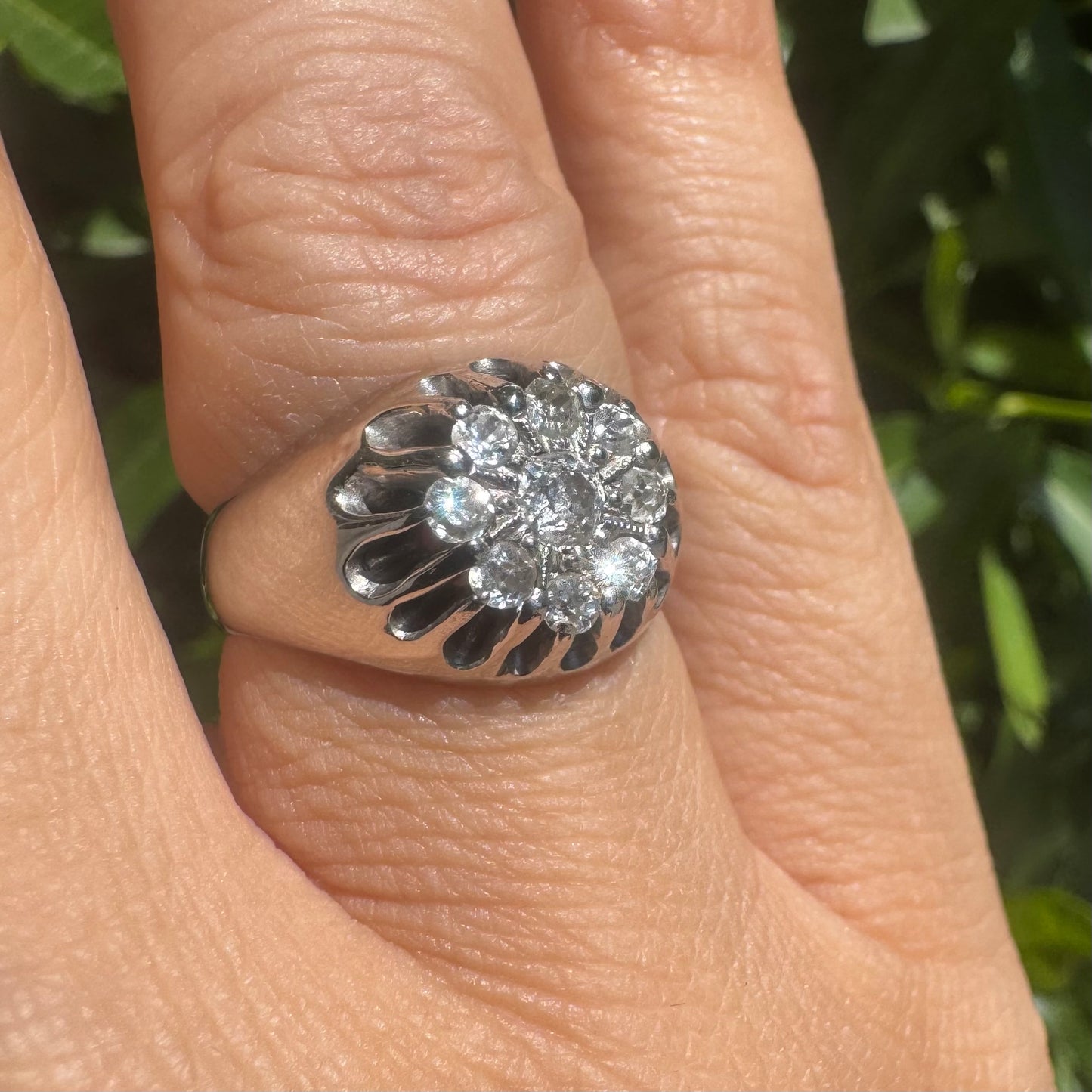 14K gold ring set with a cluster of old cut diamonds arranged in a floral design