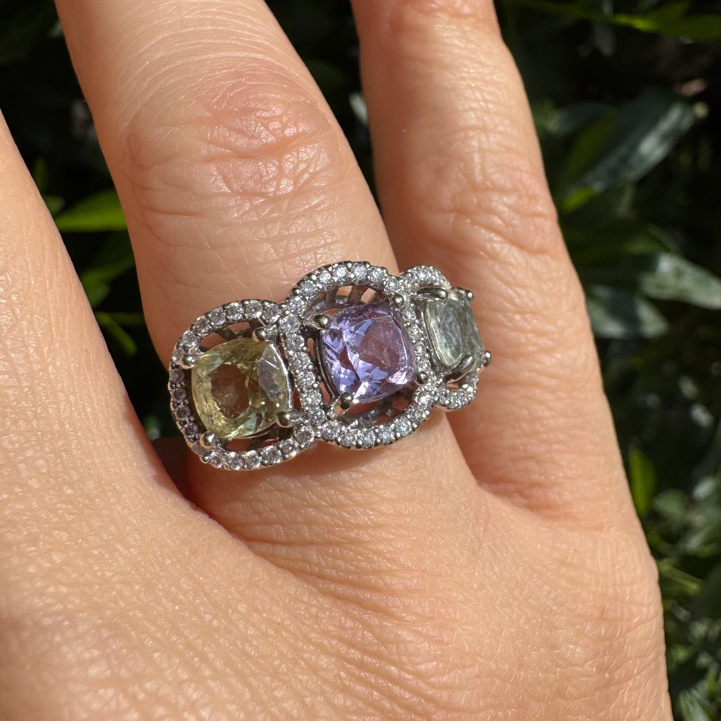 18K gold ring set with three pastel gemstones in soft shades of lilac, yellow and light gray