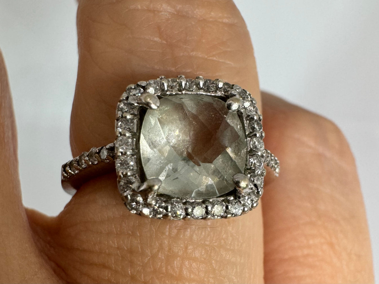 14K white gold ring featuring a cushion-cut light blue Aquamarine set in a sparkling double halo of round-cut Diamonds.