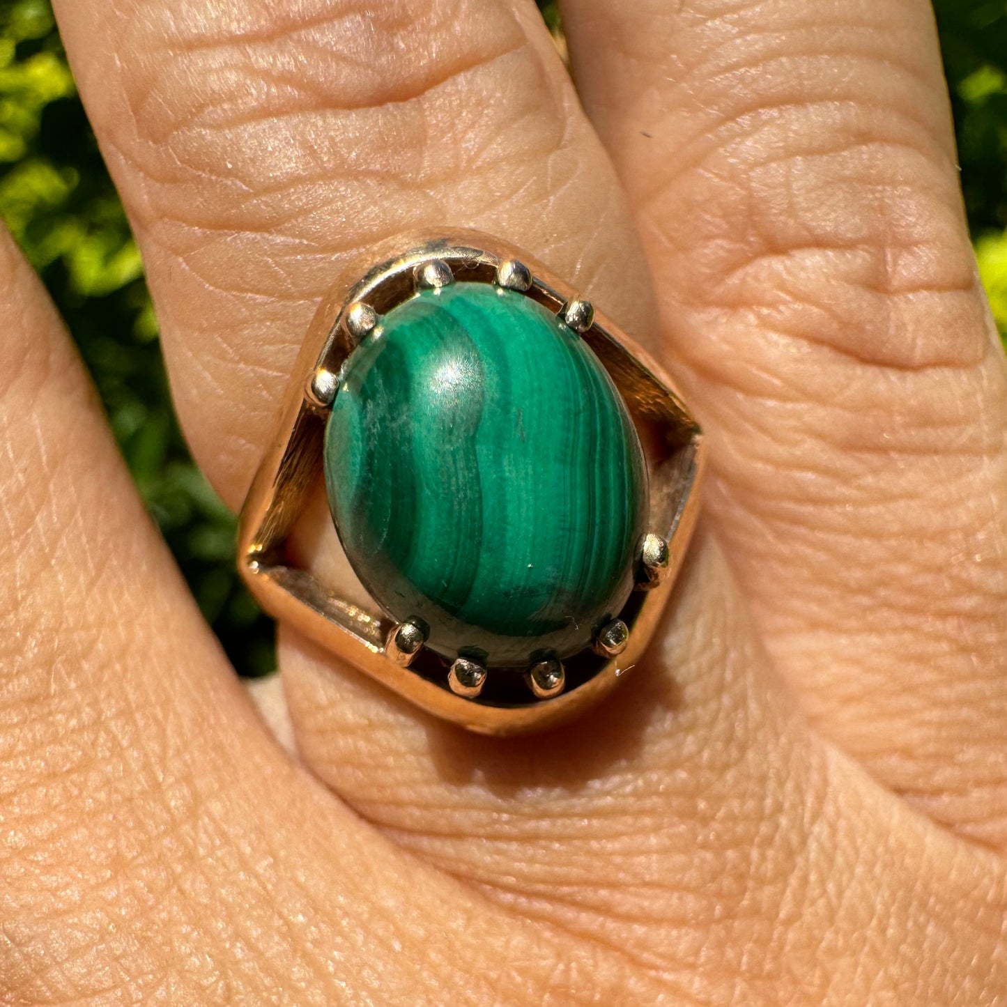 14K gold ring set with a polished Malachite cabochon