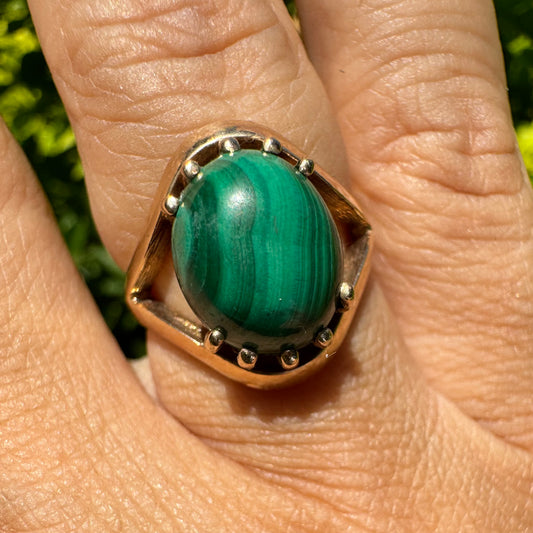 14K gold ring set with a polished Malachite cabochon