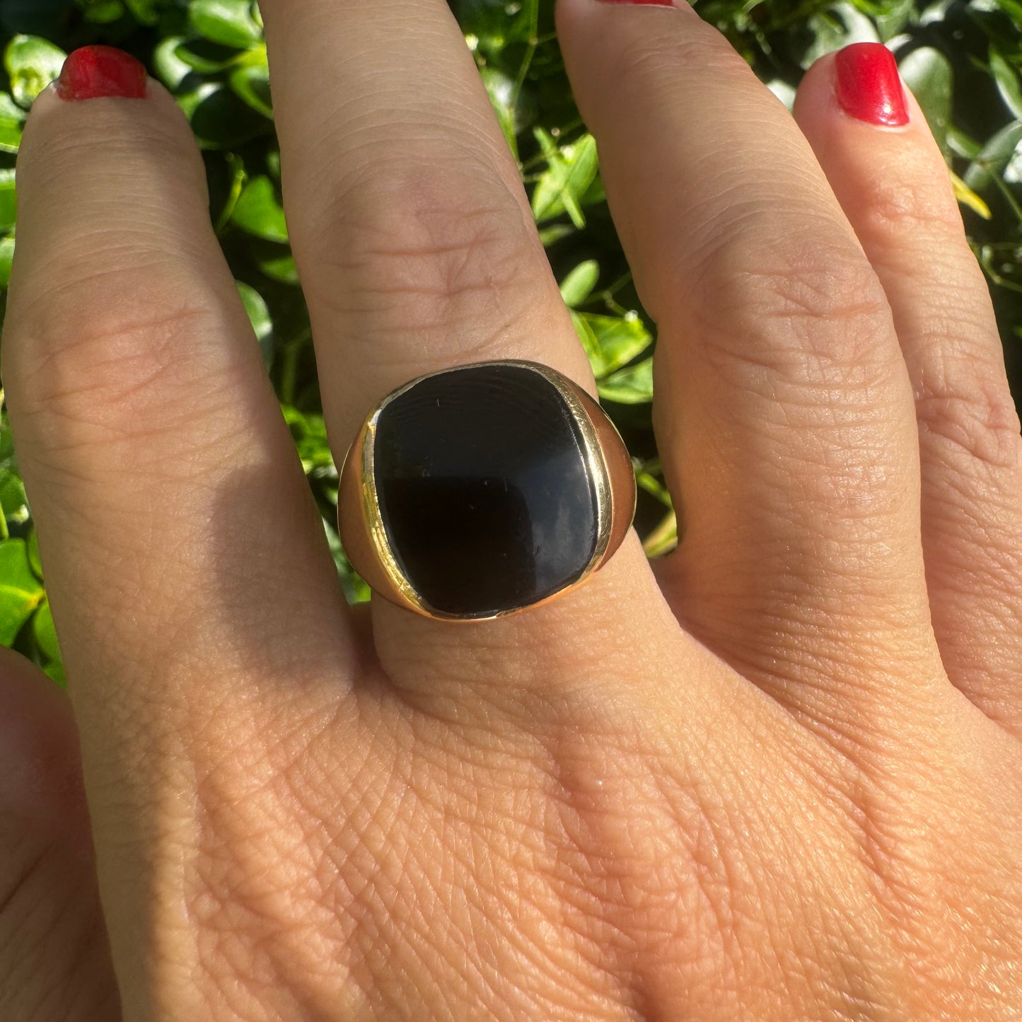 14K bold gold ring set with a smooth, square-shaped black Onyx that creates a sleek and striking look.