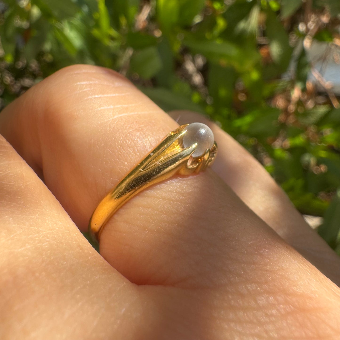 18K yellow gold ring featuring a smooth round Moonstone set in a delicate floral-inspired design.