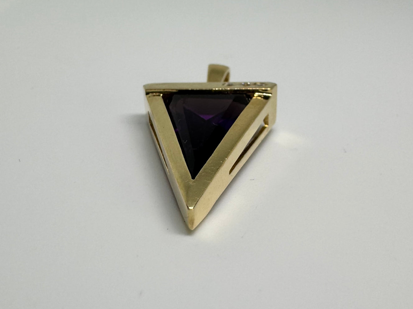 14K yellow gold pendant set with a triangular-cut amethyst and three accent diamonds