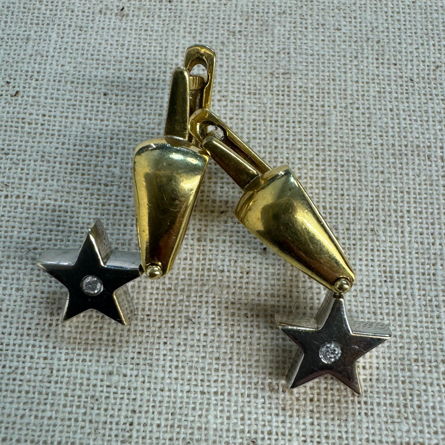 18K gold earrings set with a sparkling Diamond at the center.