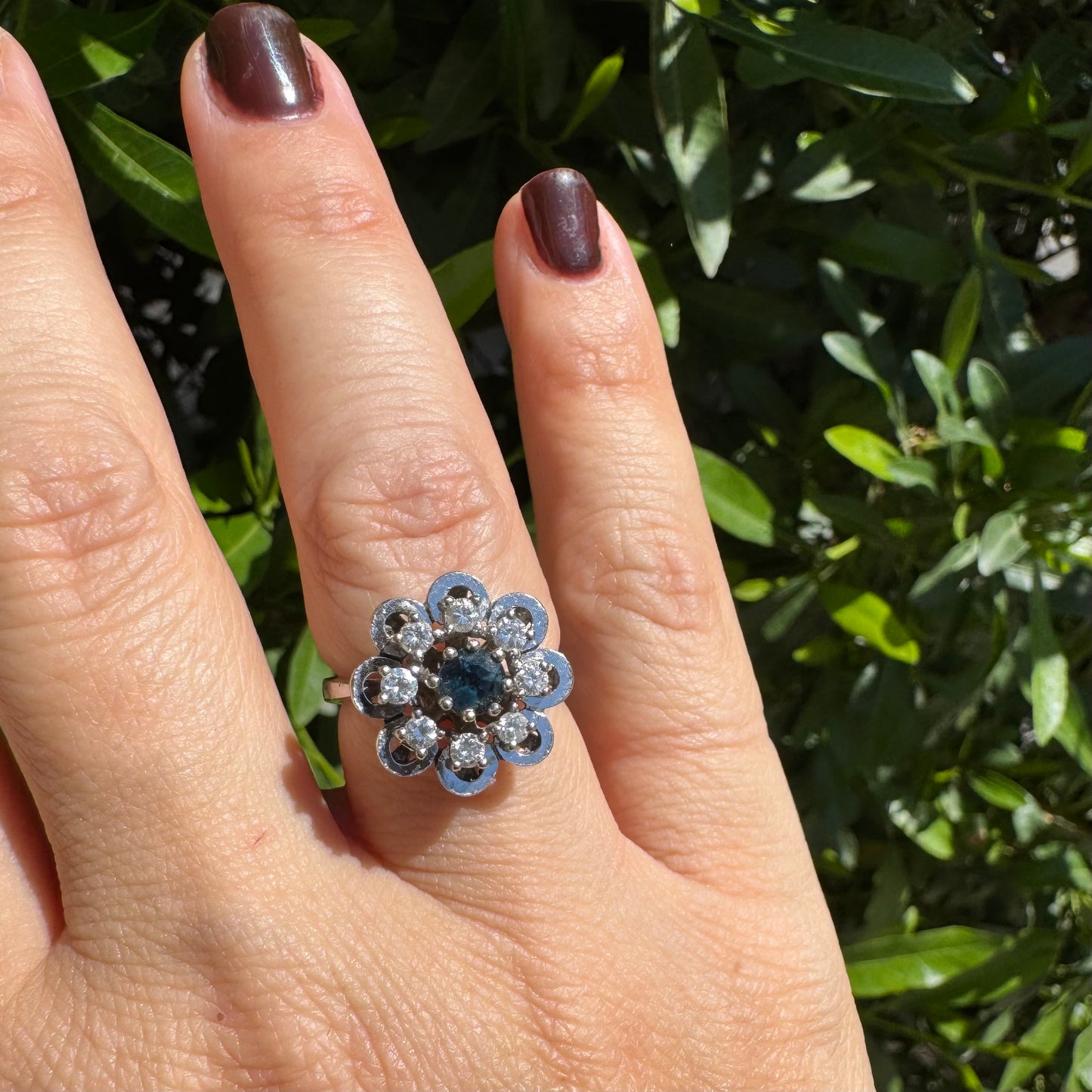 14K gold floral ring set with a round deep blue Sapphire at its center & Diamonds