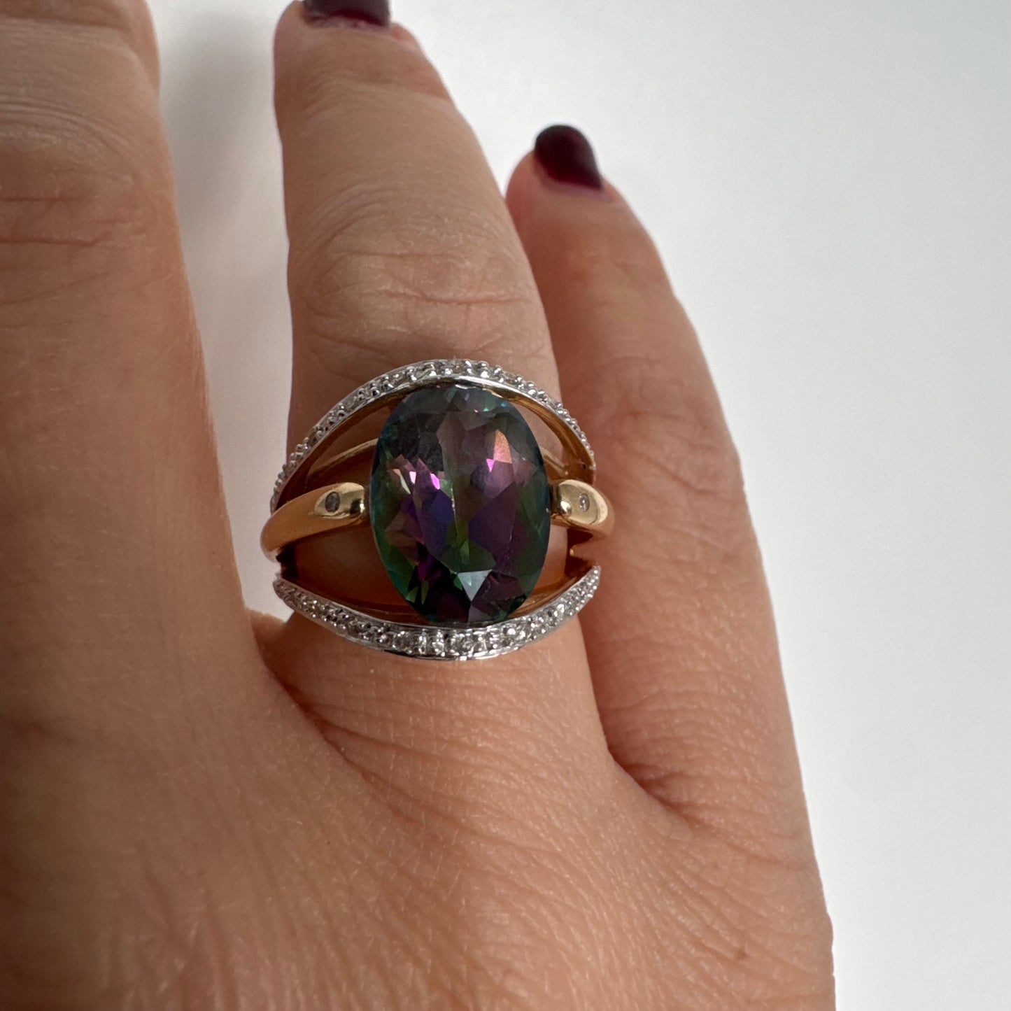 14K gold ring set with an oval Mystic Topaz