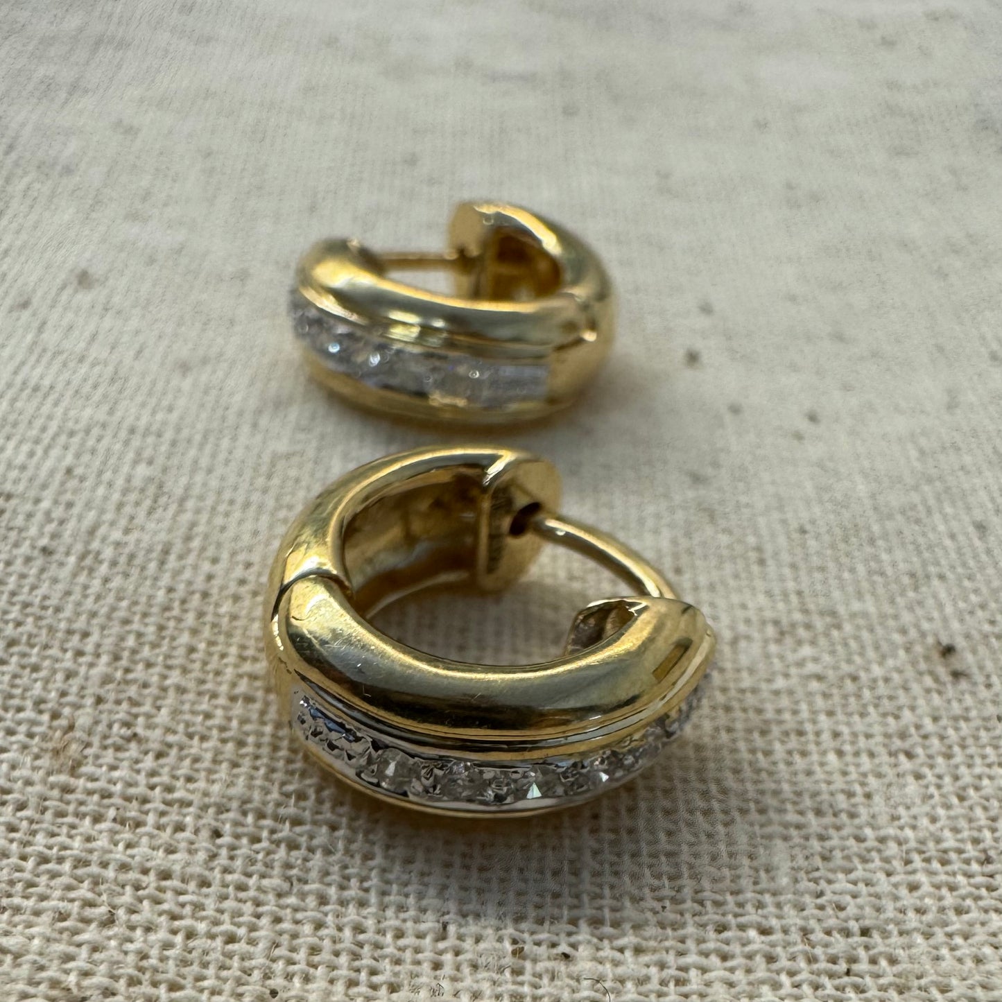 14K gold hoop earrings set with a row of sparkling Diamonds in a sleek channel setting