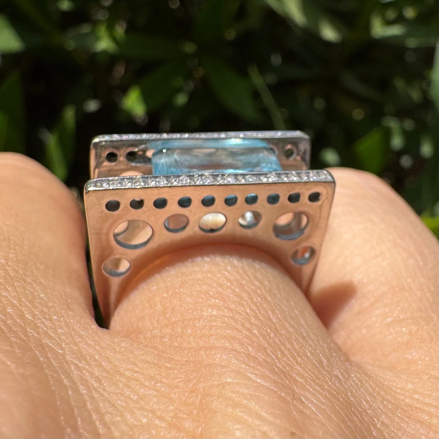 18K gold ring set with a stunning Aquamarine centerpiece held between two sleek gold bars set with delicate Diamonds.